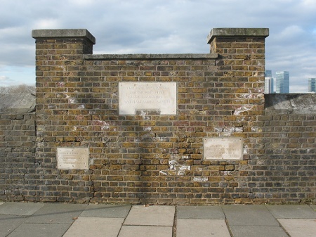 These plaques are on the river wall directly outside 1164174. The text reads: [TOP] This wall was erected - and the piles fixed - Anno Domini 1817 - William Smith, Warden. [LEFT] Variable high tides - March 30th 1874 - Joseph Giles, Warden. [RIGHT] Extraordinary high tide - January 7th 1928 - when 75ft of this wall were demolished - Leonard Collyer, Warden.